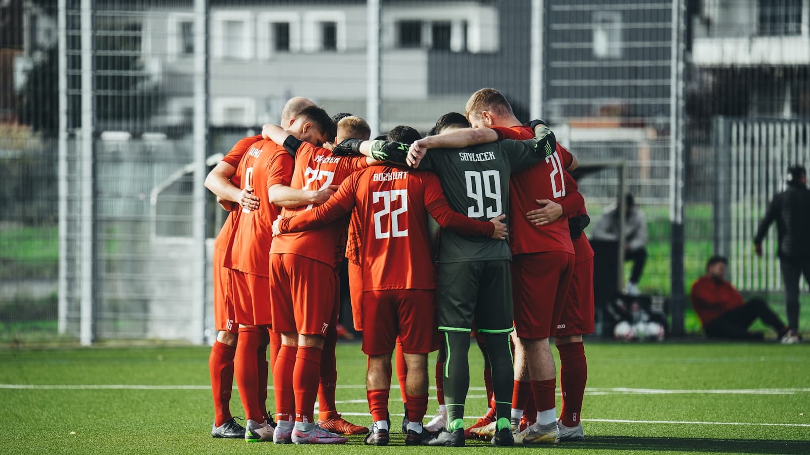 A local soccer team huddled together on the field