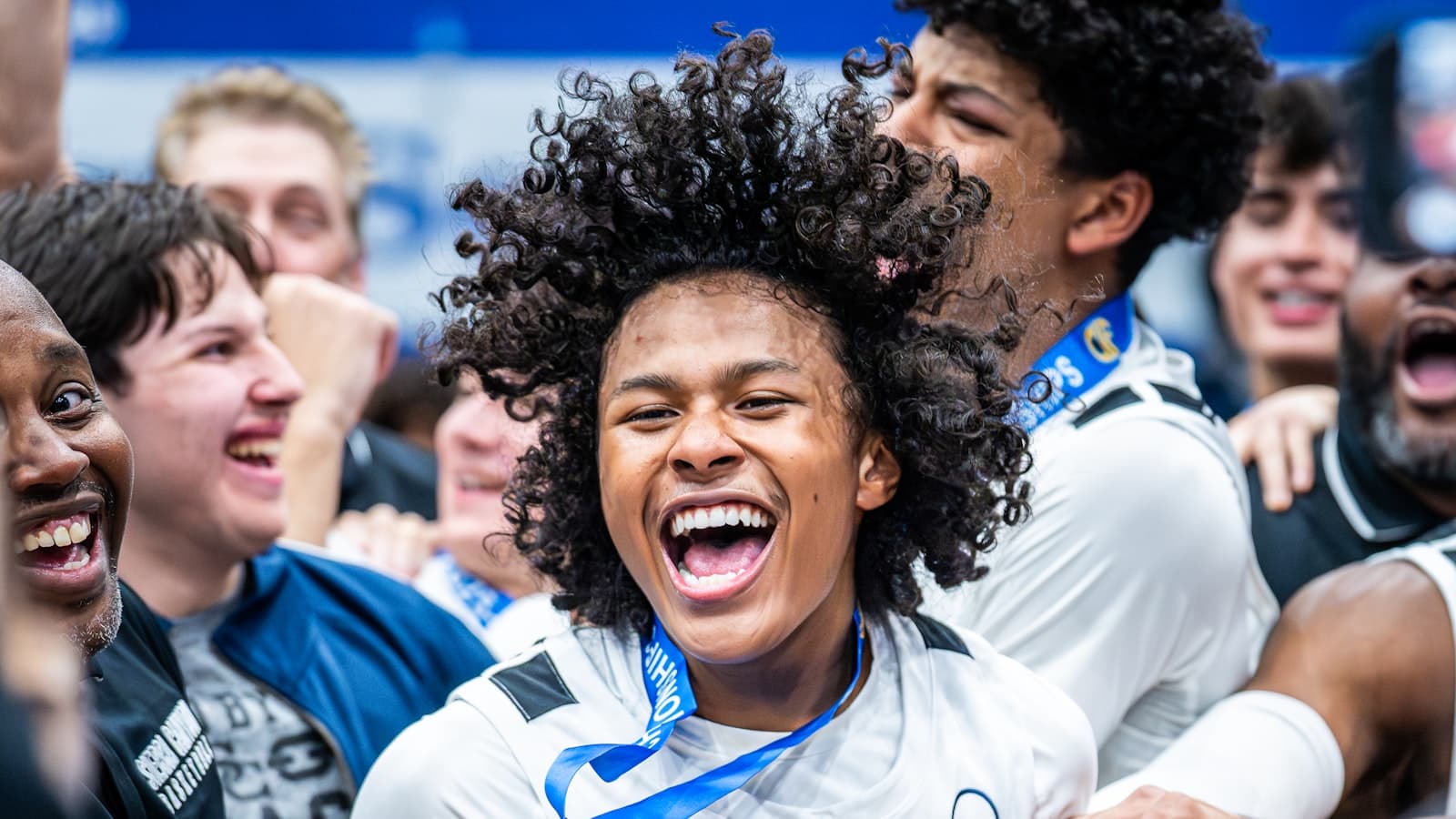A young basketball player celebrating a win with teammates on the court